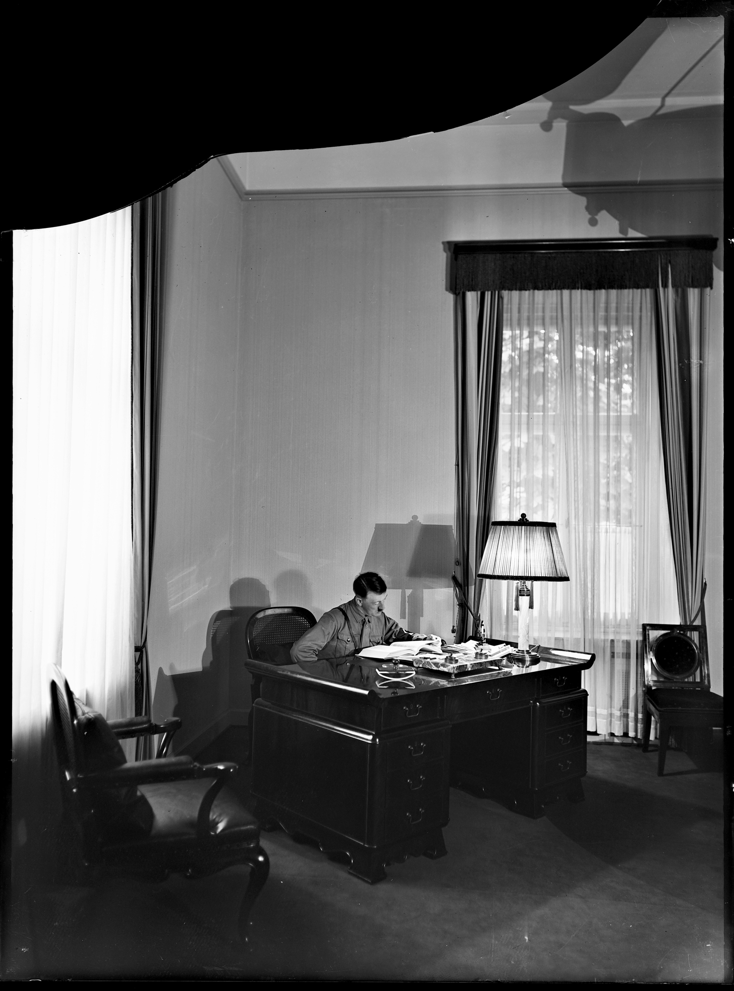 Adolf Hitler in his office of Munich’s Braunes Haus a few days after the opening of the building (Heinrich Hoffmann photo)